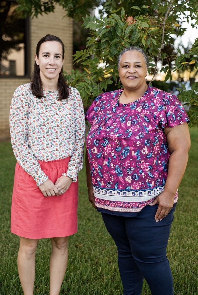 2 women standing together 