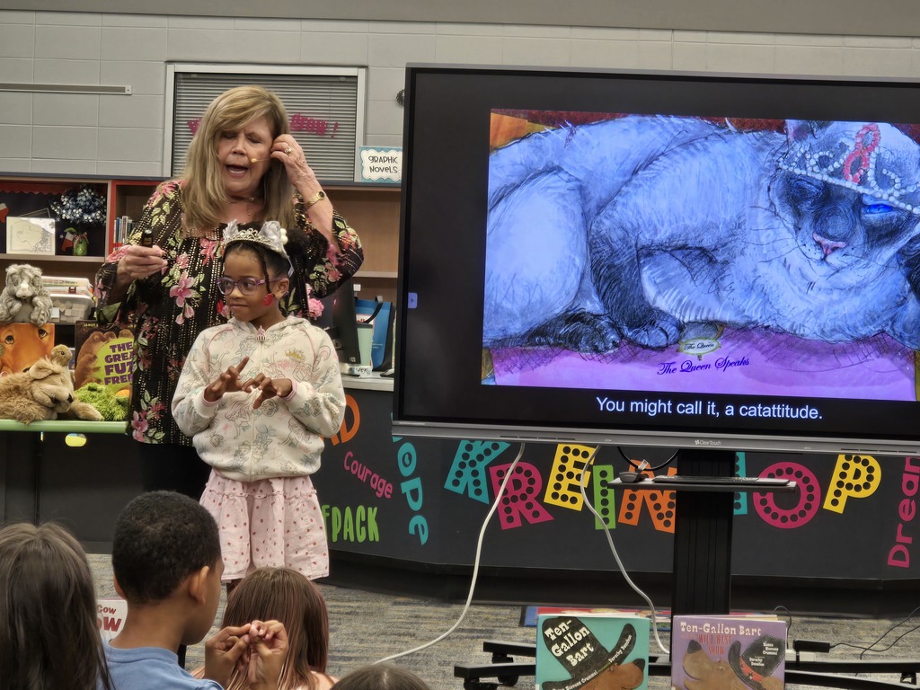 Students acting out part of a book