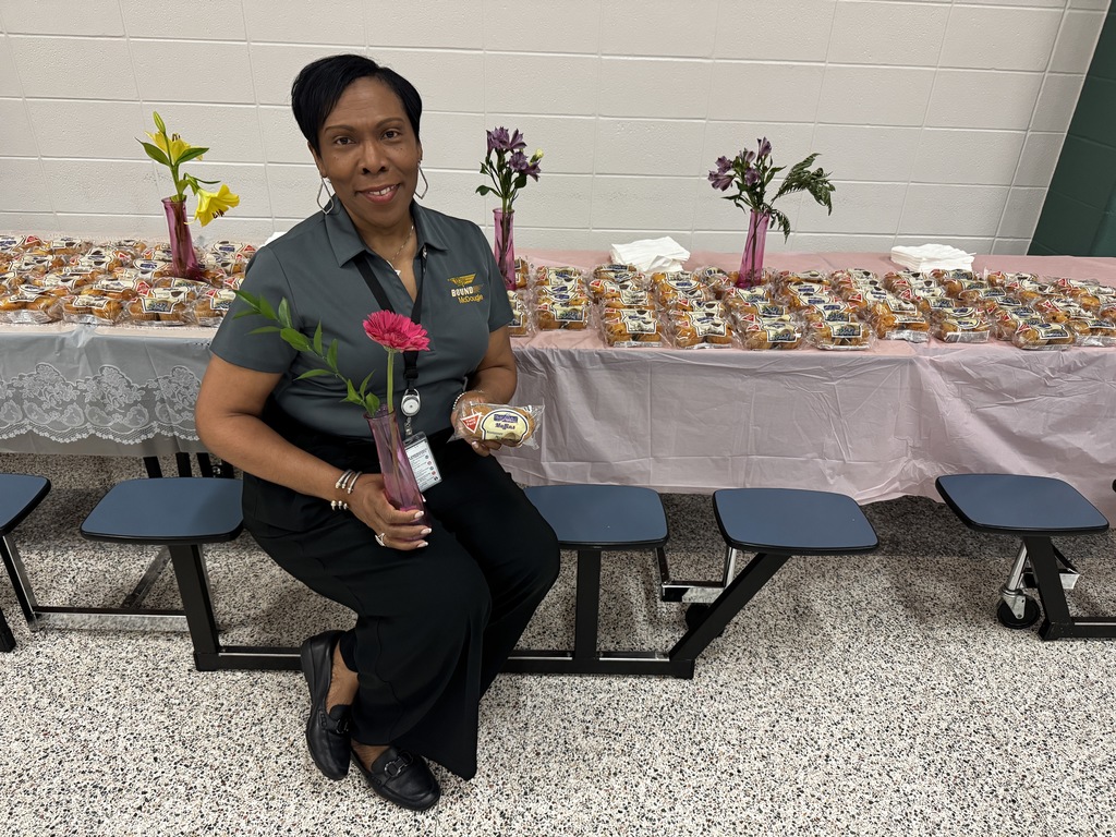 Lady with flower and muffins.