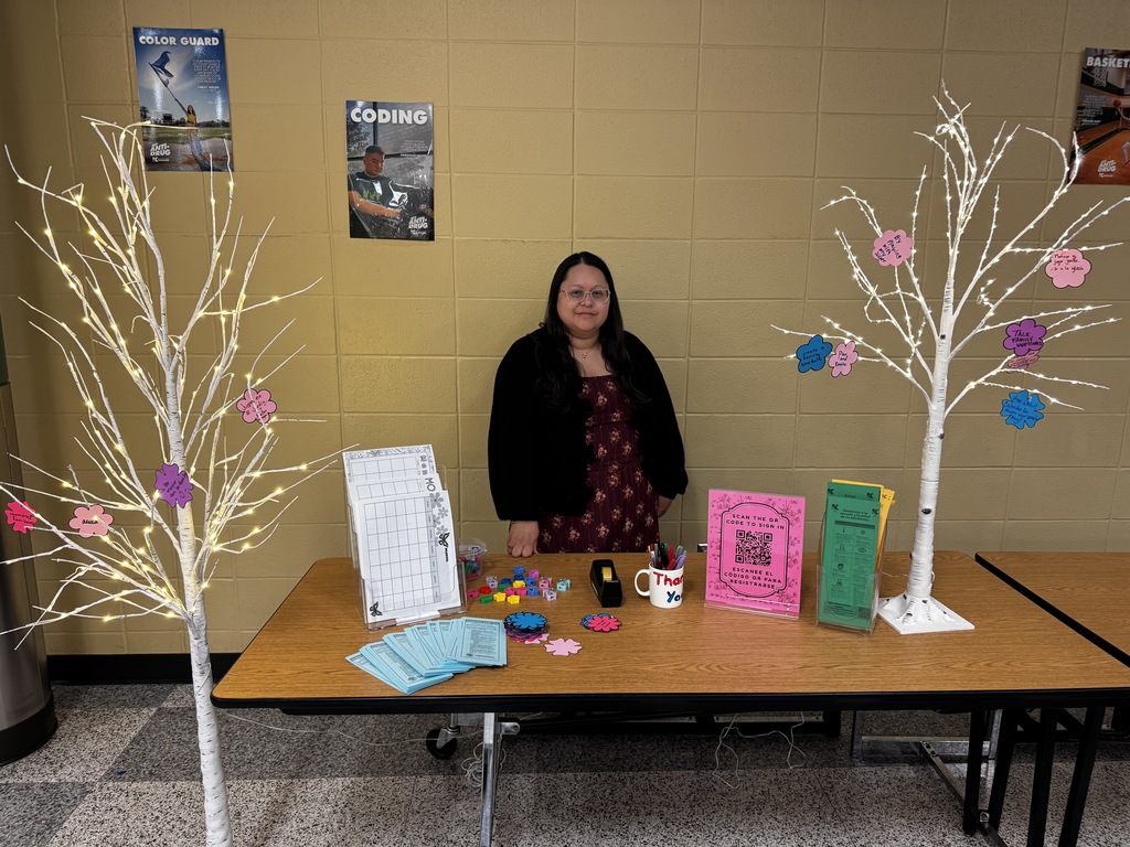 Lady standing at a table with information for families.