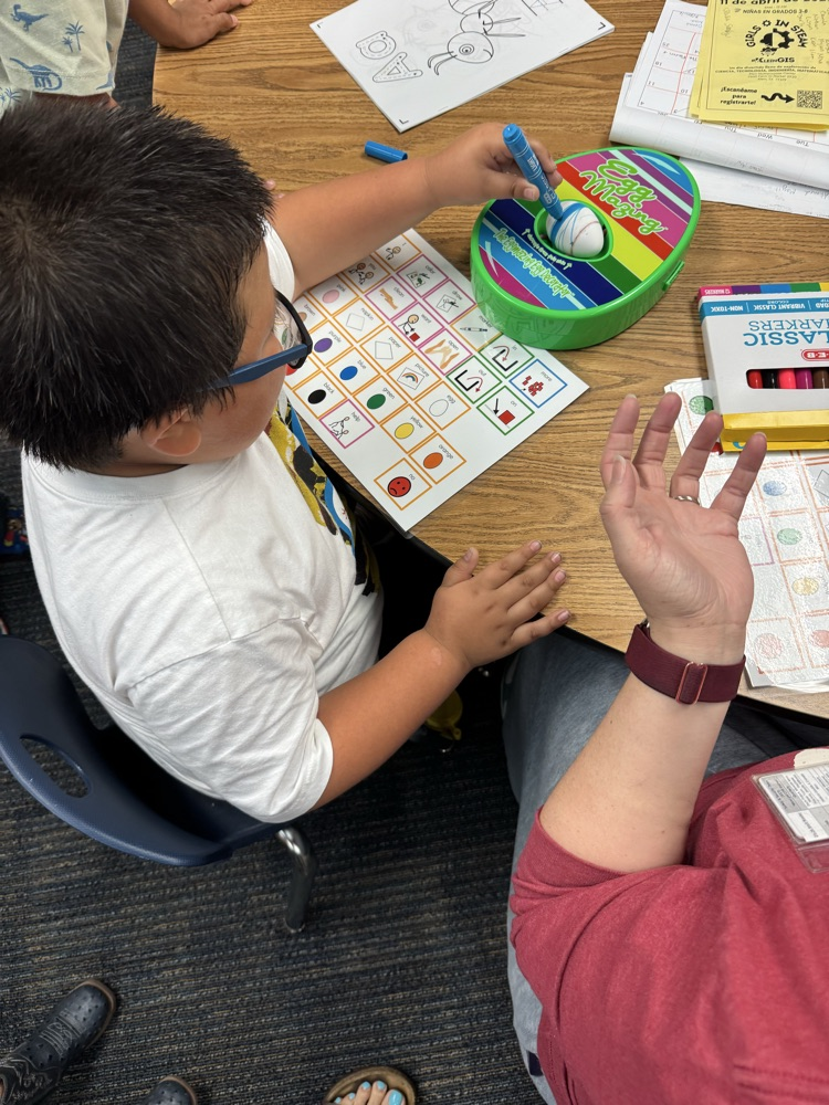 students coloring eggs