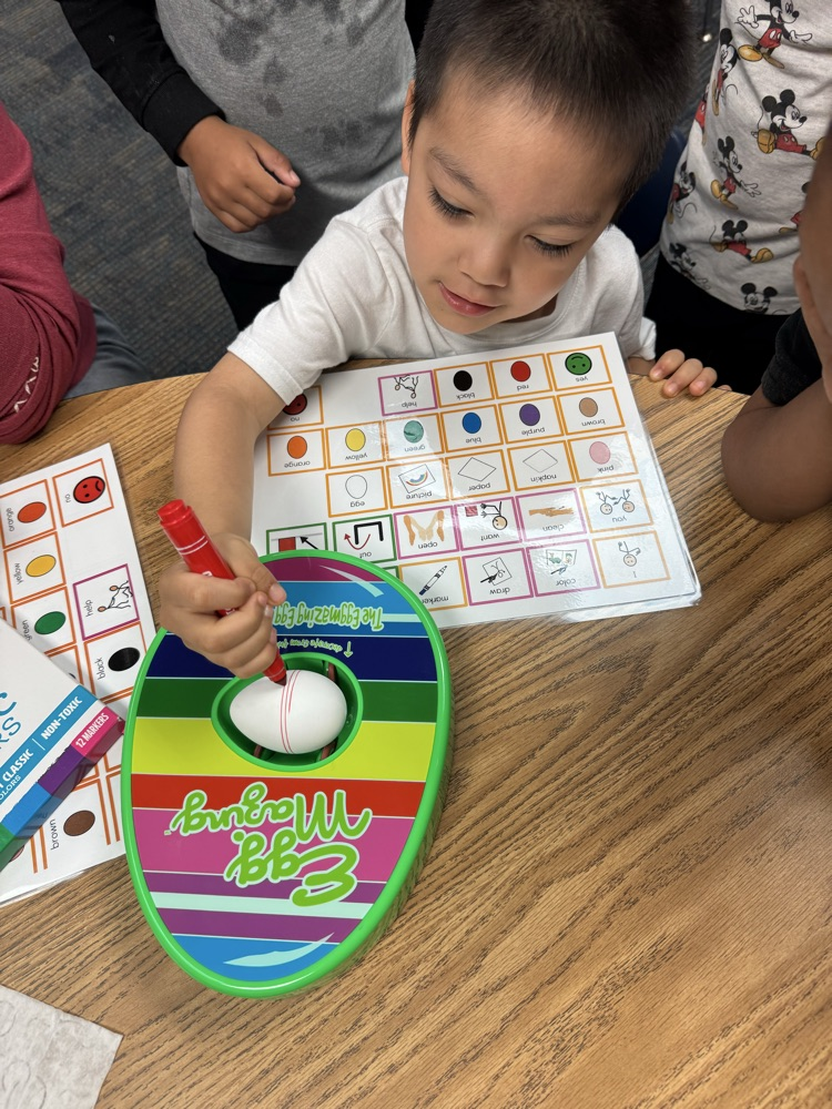students coloring eggs