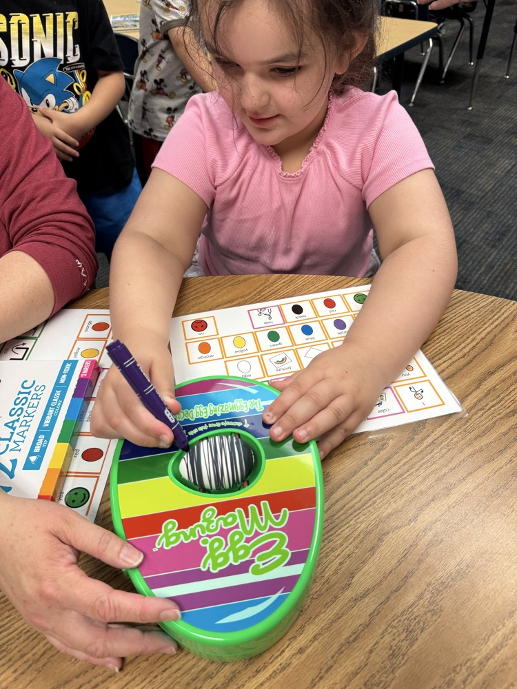students coloring eggs