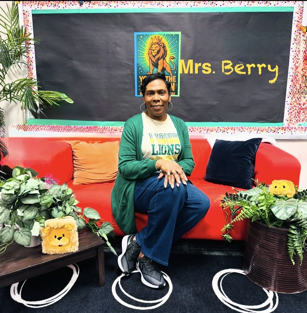 Principal  Berry  sitting on couch