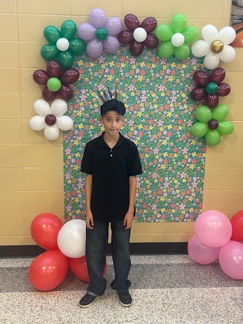 Student standing by sign.