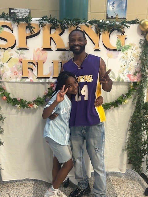 Father and daughter at school dance .