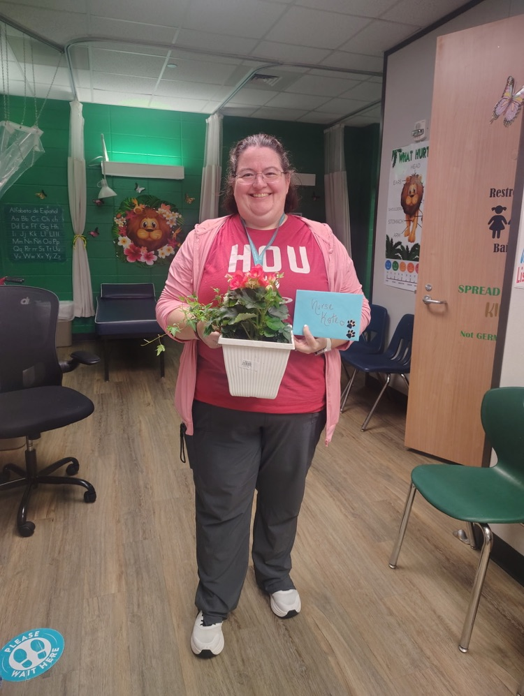 Nurse holding plant. 
