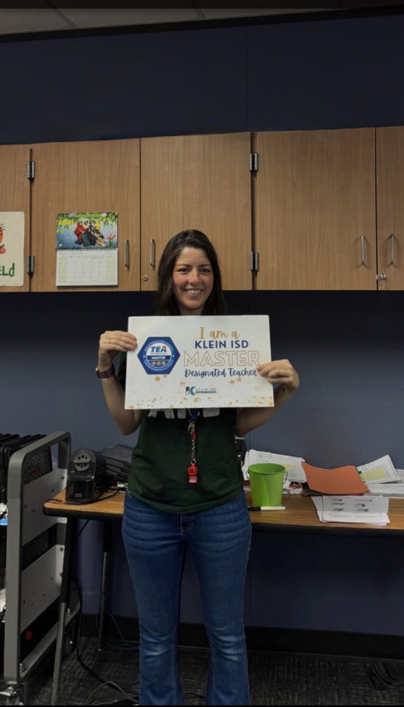 An educator holding certificate of accomplishment. 