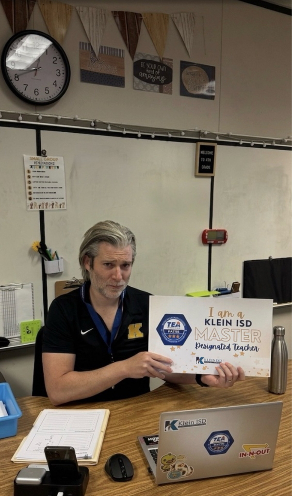 A teacher showing her certificate of achievement. 