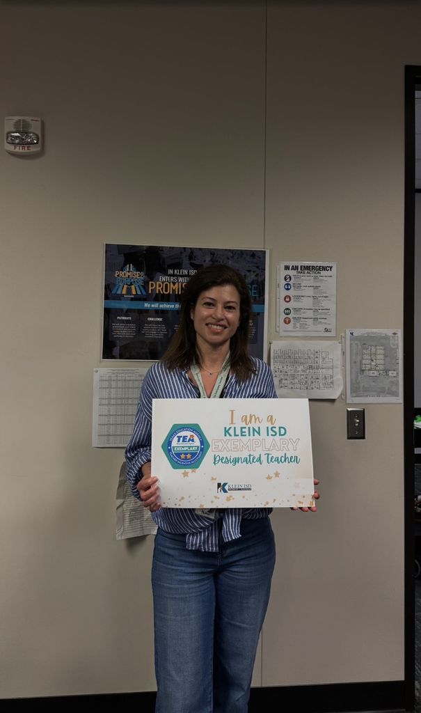 A teacher showing her certificate of achievement. 