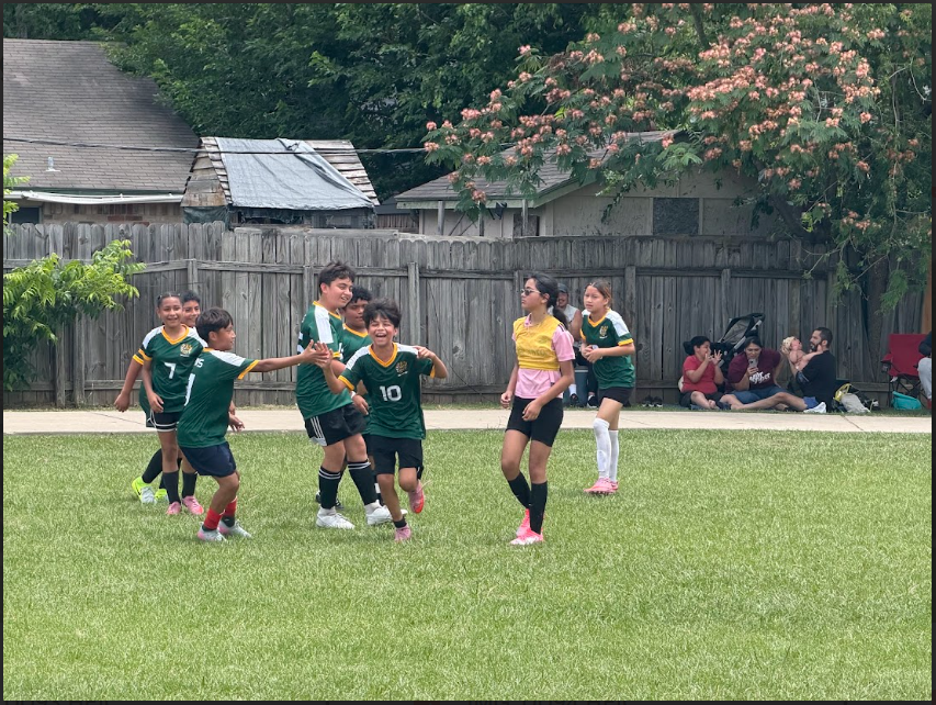 A soccer player running with excitement after a goal scored.
