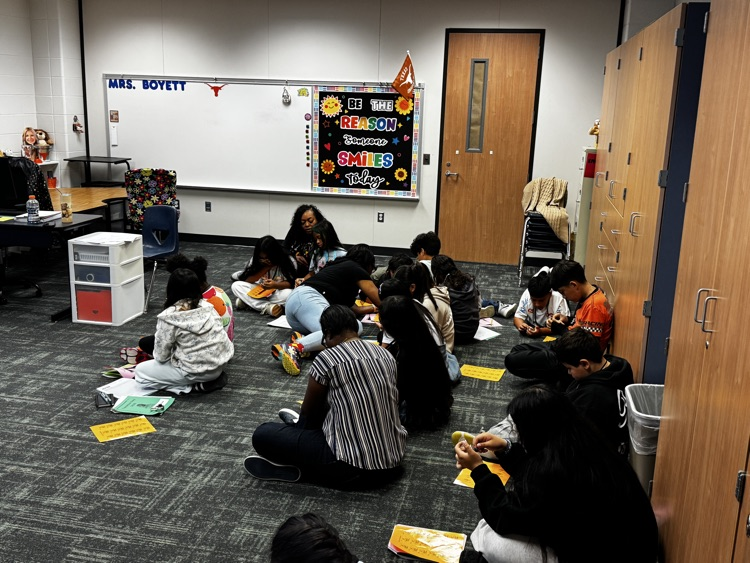 Teacher helping students learn to open locks. 