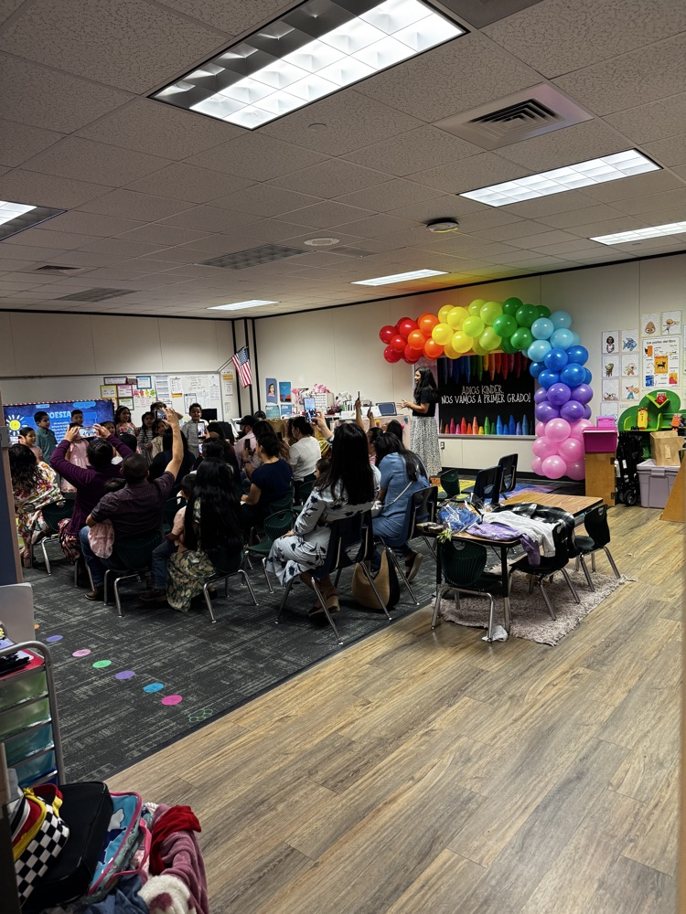 Room filled with Parents ready to watch their children at the end of Kindergarten. 