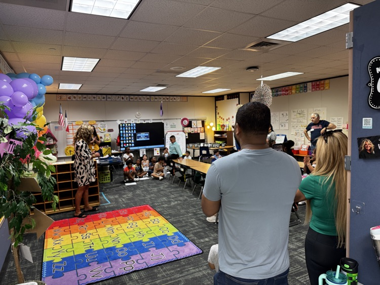 room full of excited families for their kindergarten student. 