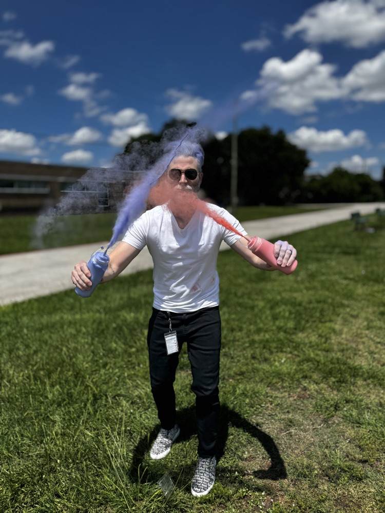 teacher spraying colored powder! 