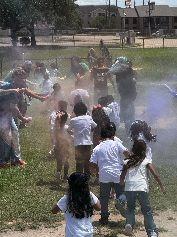 students running through the color run. 