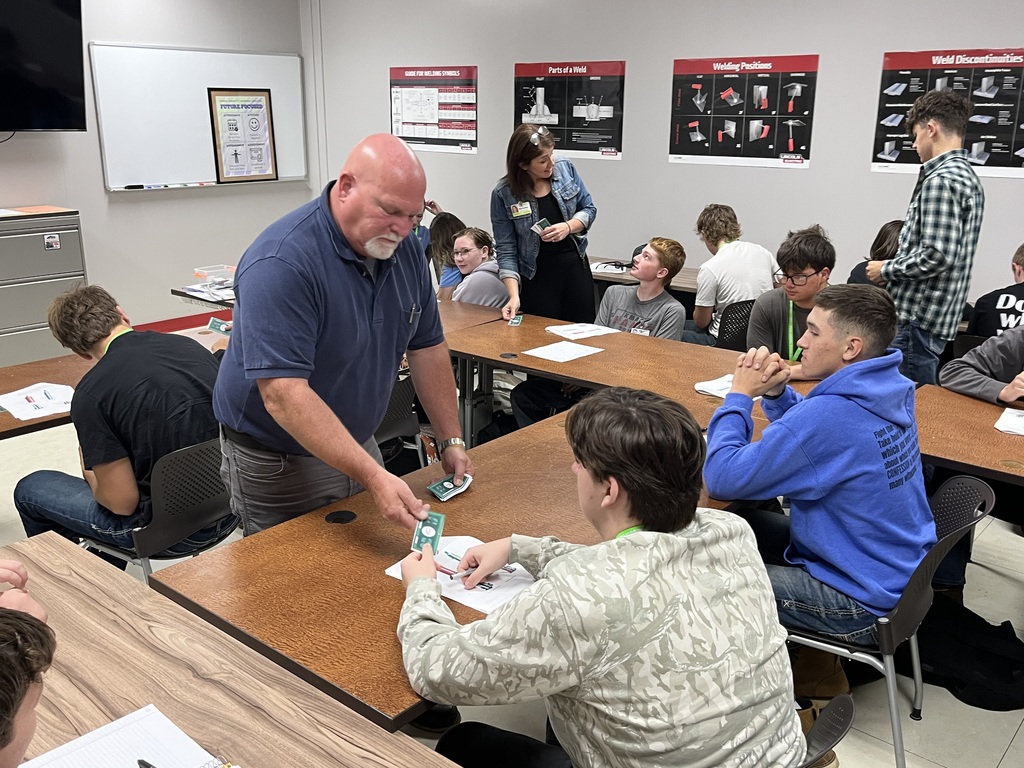 KCCC staff members passing out career center cash.