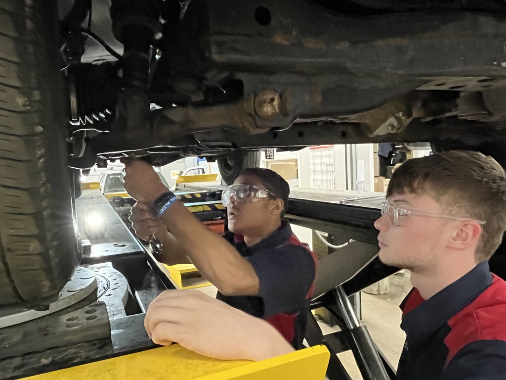 Students in Automotive Technology fixing an issue on a vehicle