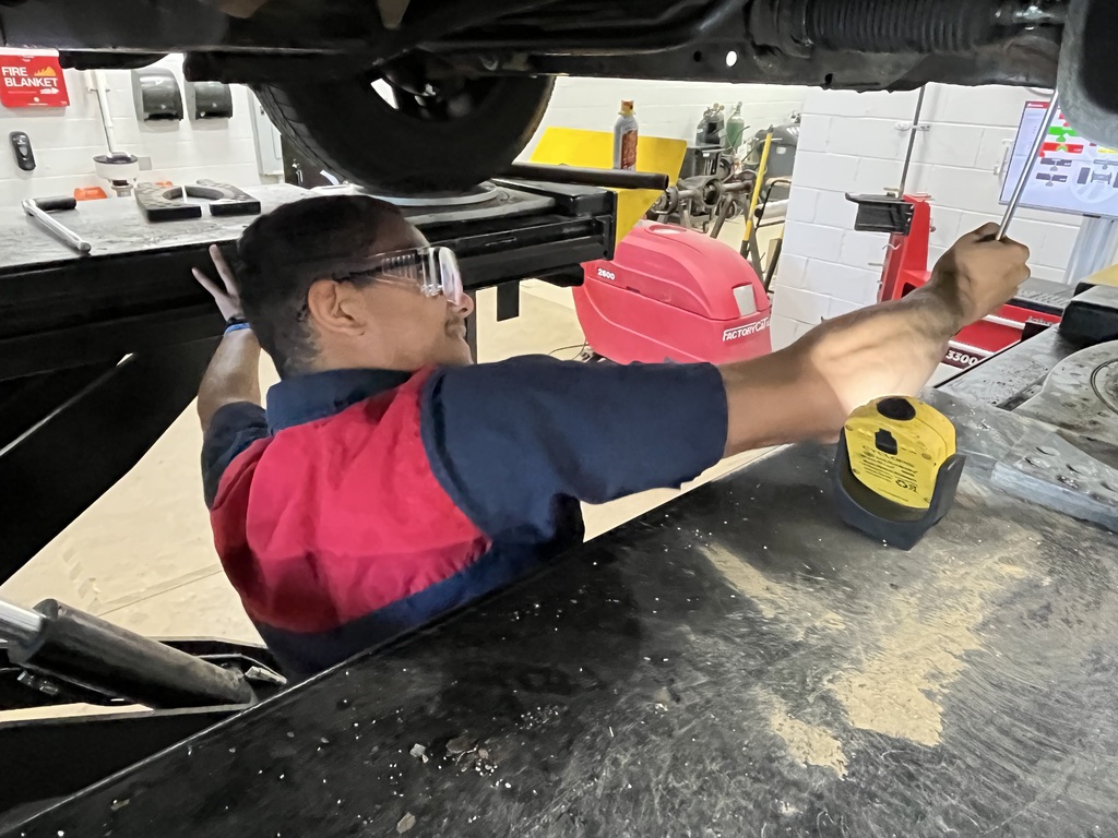 Student in Automotive Technology working through an issue