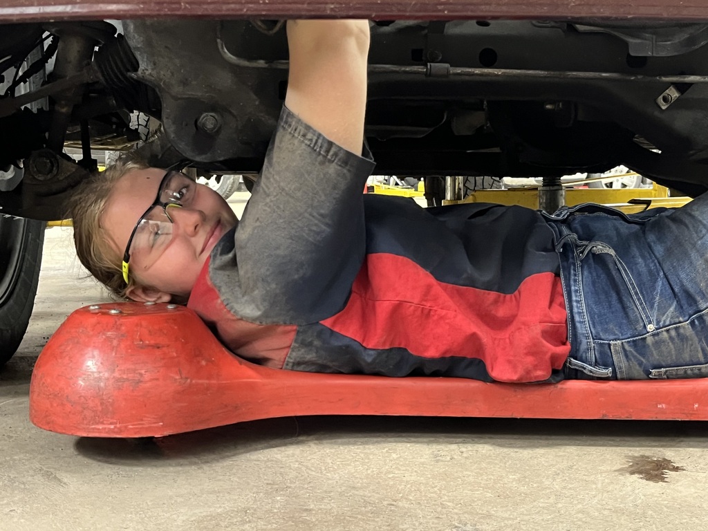 Auto Tech on the roller evaluating the vehicle