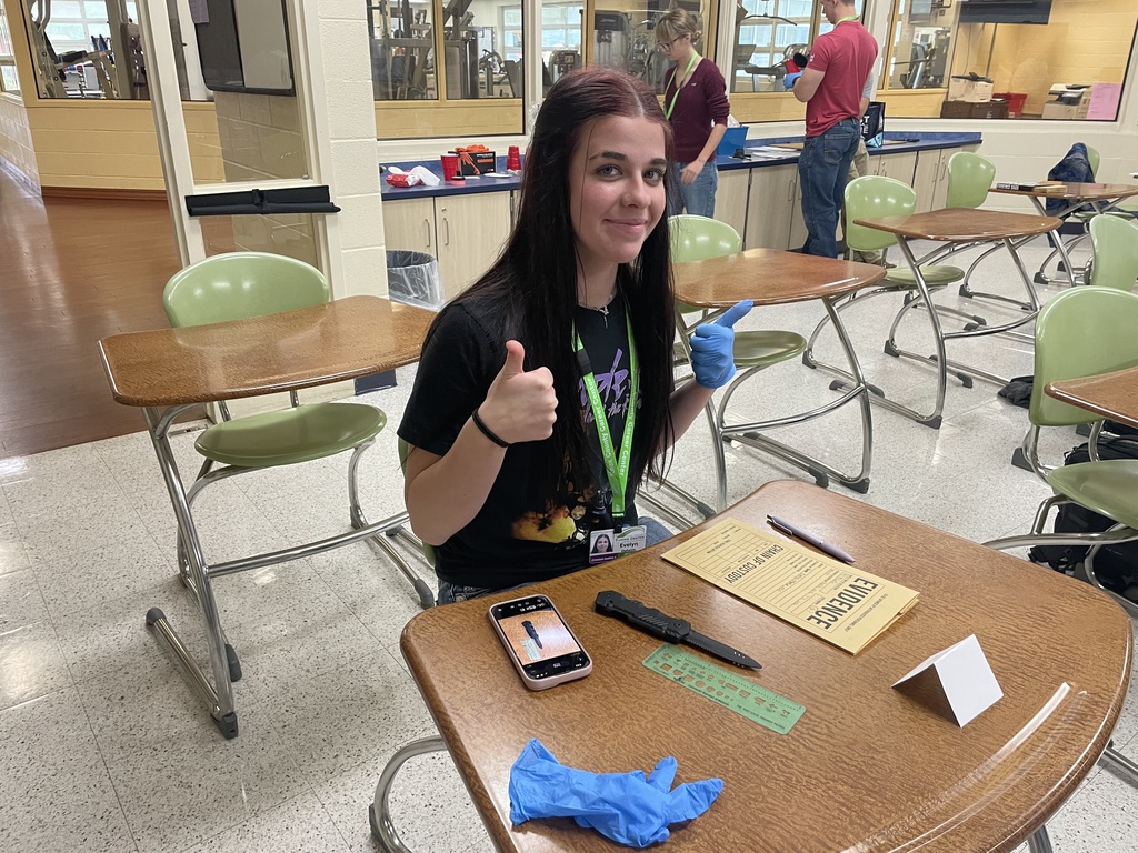 Students in Criminal Justice writing information down on evidence card.
