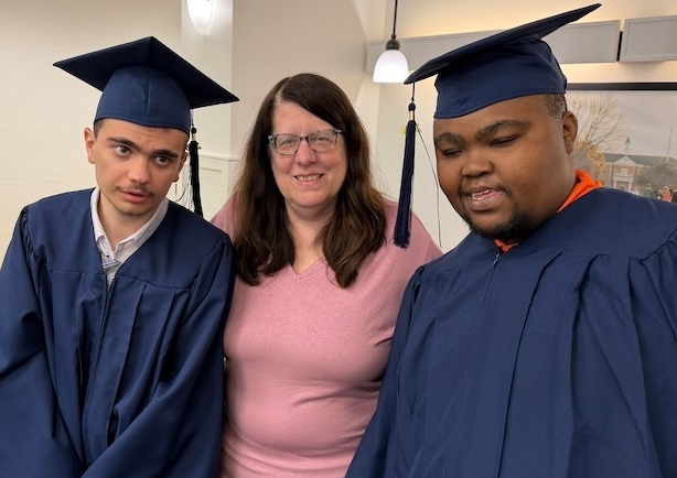 Transition U Director Kim Hood stands with 2026 graduates Colton Young, left and Eddie Atkinson