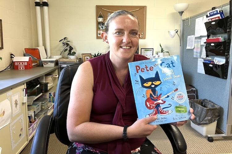 Amy Krumm displays one of the books she uses in her work with special needs children