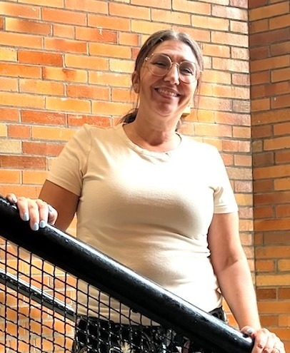 Adri Trace pauses on a stairway at the Knox Learning Center