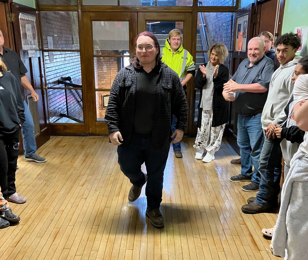 Tristan Carter begins the long walk down the main hallway of the Knox Learning Center as staff and students line the walls for a “clap out” that signaled his graduation.