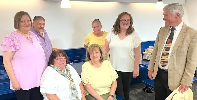Superintendent Dr. Timm Mackley salutes Knox County Educational Service Center employees who received Doctor of Thinkology degrees Tuesday. Seated are Gwen Smith, left, and Barbara Waite. Standing, from left, are Ronda Beheler, Joe Mazzari, Michelle Kipp and Jackie Nutt