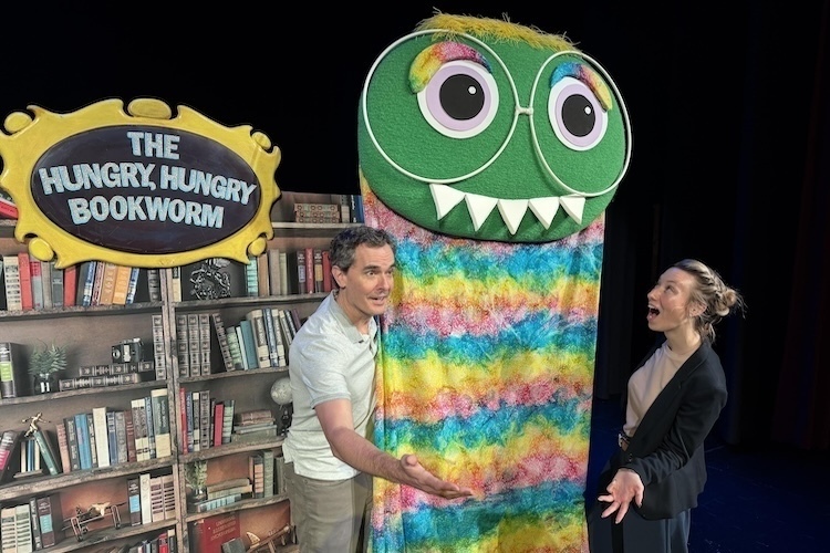 Taylor Gingery of the Knox ESC reacts as puppeteer Dylan Shelton displays The Hungry, Hungry Bookworm.