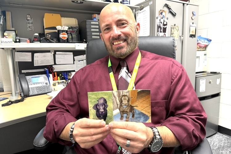 Derek Fisher displays photos of Dallas, left, and Leo.