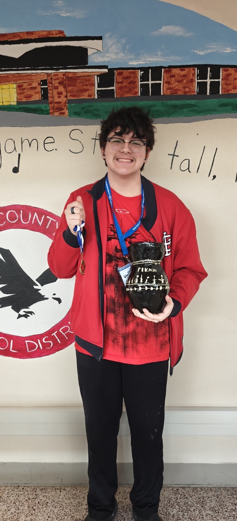 Wyatt Vargas holding a medal and his prize winning Pikmin themed Greek Vase