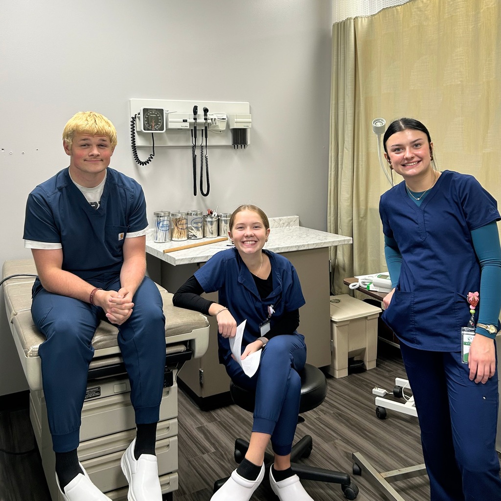 Three MA students in the lab, smiling