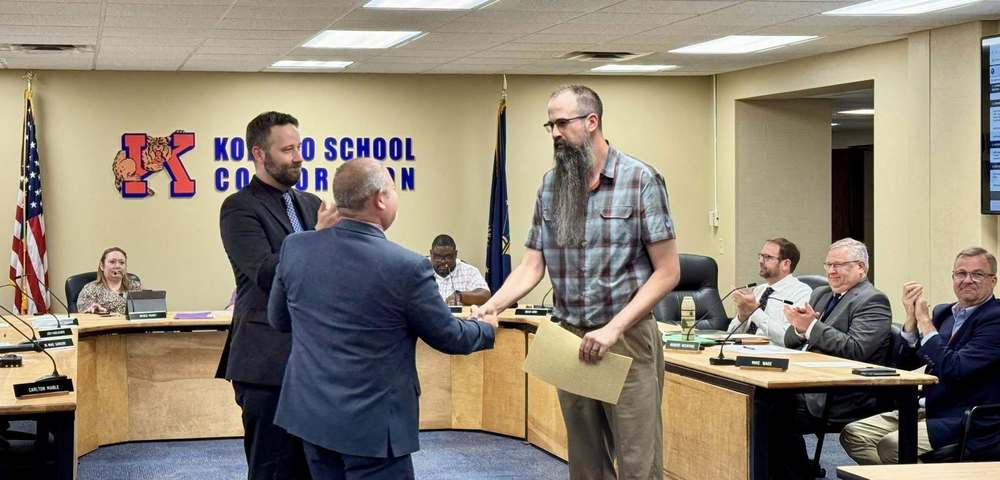 KHS Science Teacher Mr. Lorenz shaking hands in the board meeting room