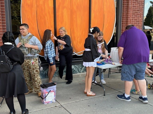 Environmental Club students set up their booth for Kokomo's October First Friday event.