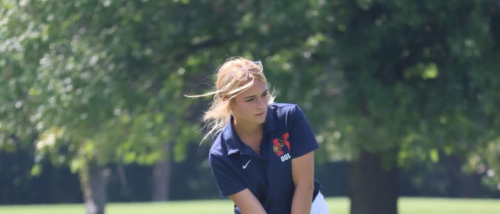 Junior Mia Drake warms up before a home golf match.