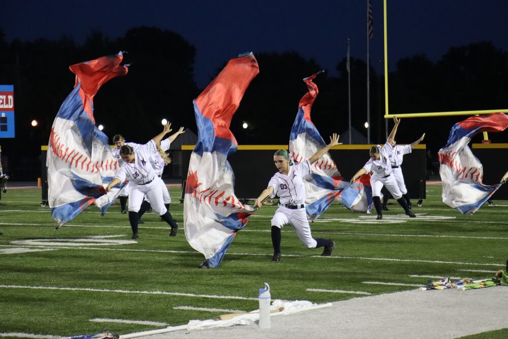 Members of the KHS guard perform their competition show, Batter Up!, at the marching band and guard's senior night.
