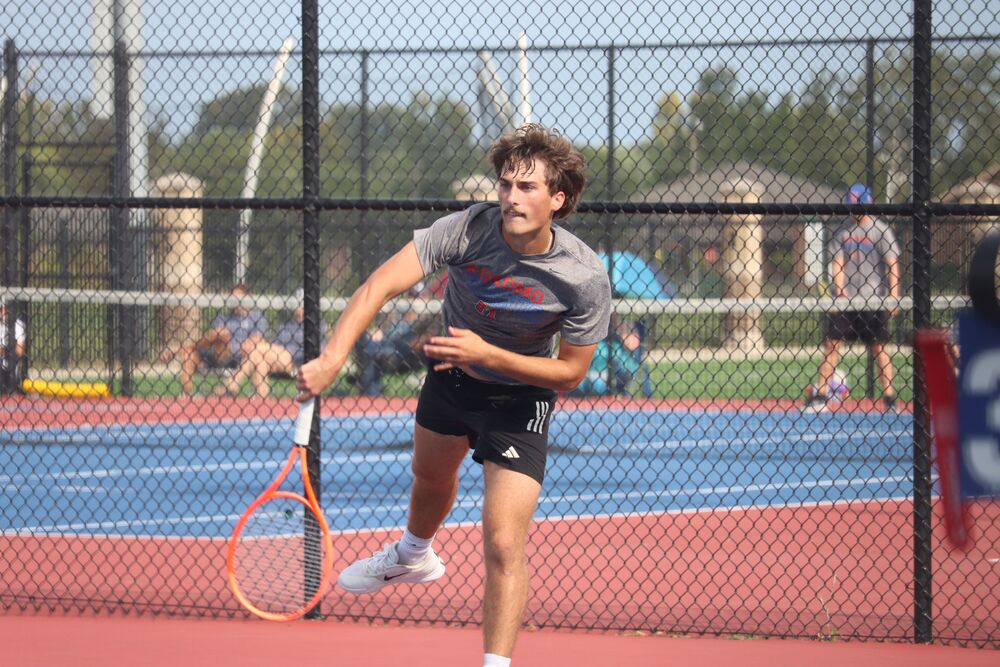 Senior Micah Taflinger sends the ball over the net during a home match against Mount Vernon. Taflinger helped the Kats earn their 4th straight NCC title.