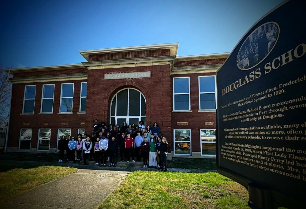 historic brick school house Douglass School signage group of students