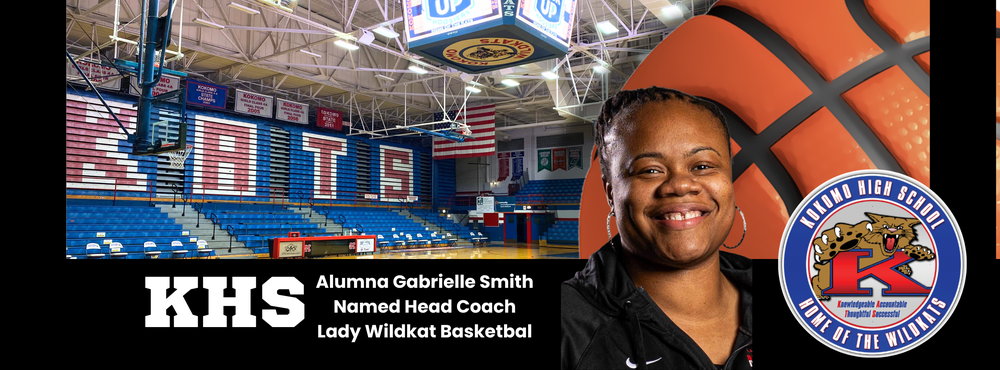 black woman smiling in front of basketball in gymnasium