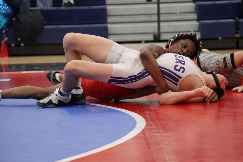 Senior Dorian Barbour pins his opponent on senior night.