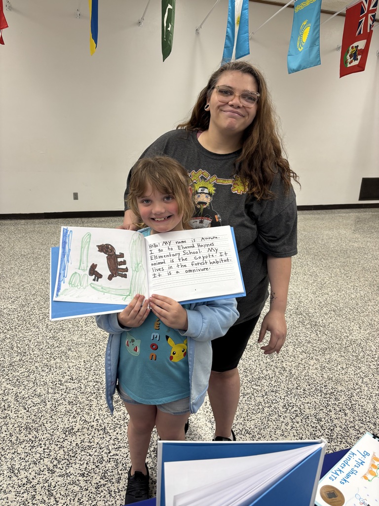 One of our young authors proudly displaying her work!