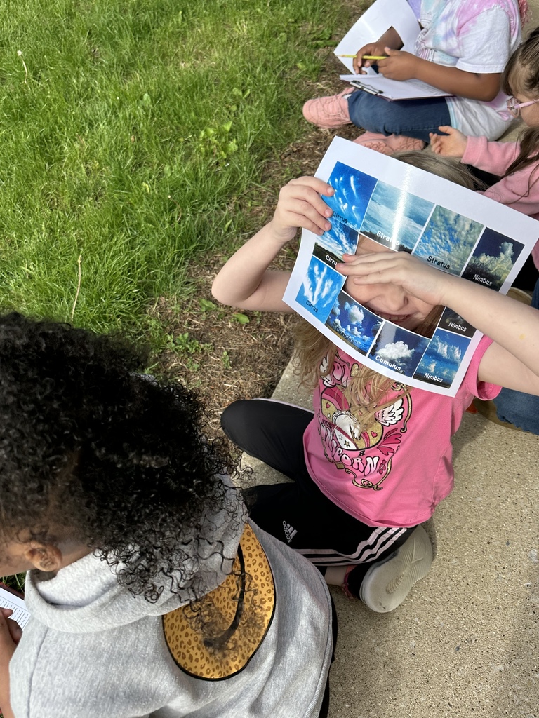 A student looks through the opening of the cloud identifier paper to show how it works.