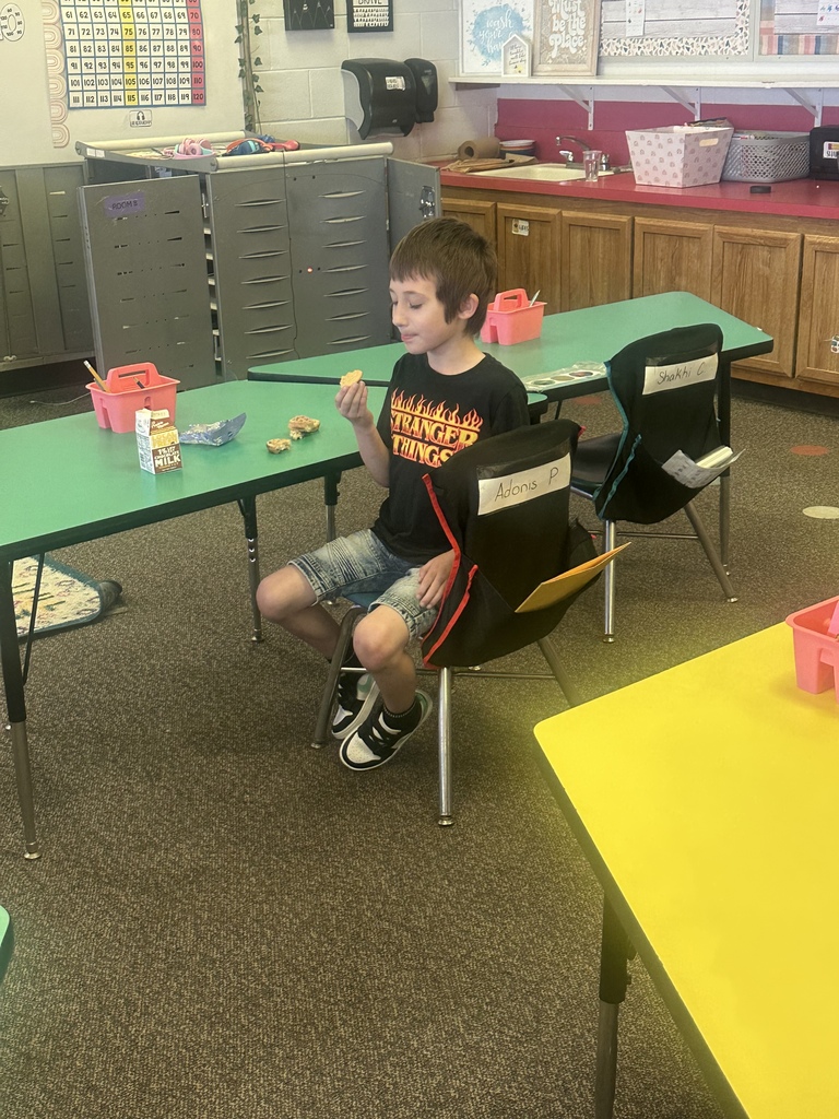 Students try dandelion jelly on a cracker.