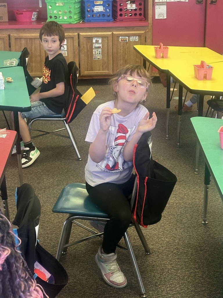 Students try dandelion jelly on a cracker.