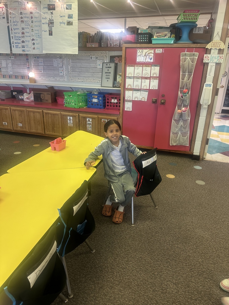 A student smiles for the camera after trying dandelion jelly.