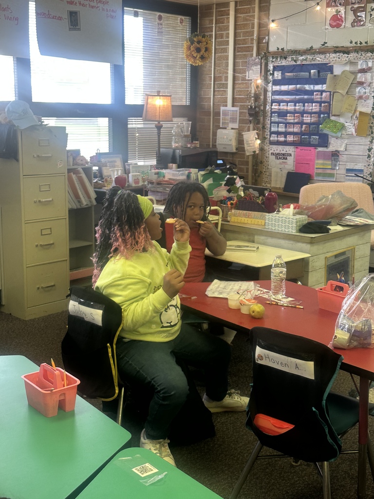 Students try dandelion jelly on a cracker.