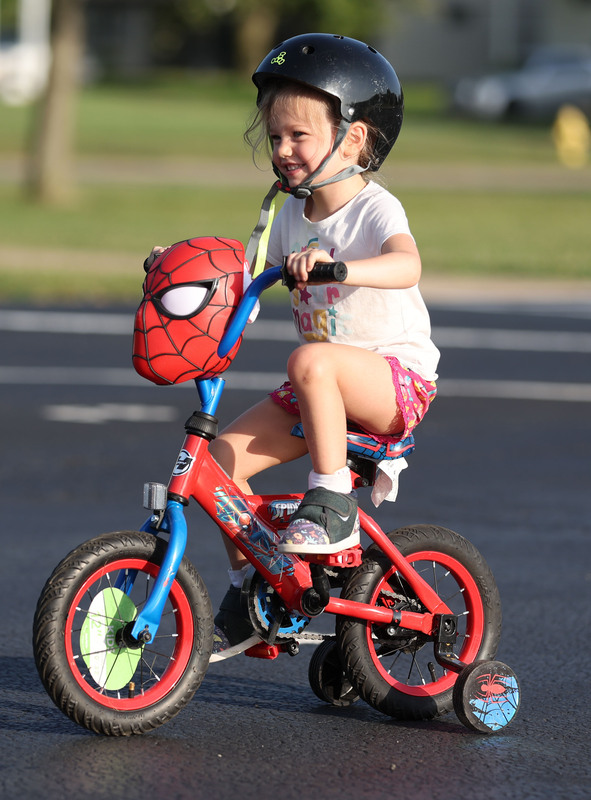little girl riding spiderman bike