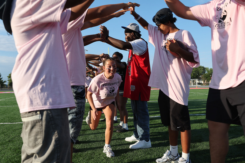 students forming tunnel with their arms